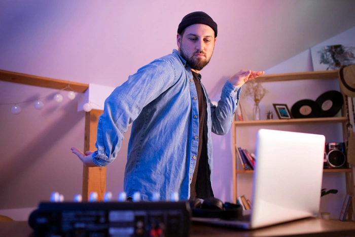 Adult learner practising dance steps at home with a laptop